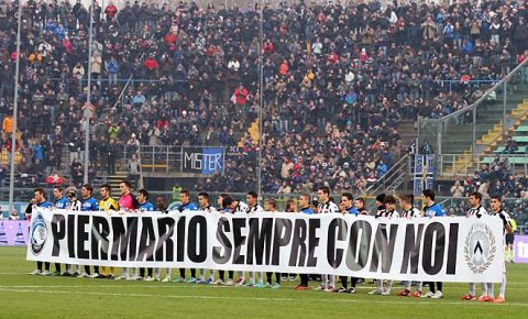 Udinese and Atalanta team display a banner to remember Livorno's Piermario Morosini prior to a Serie A soccer match in Bergamo, Italy, Saturday, Dec. 22, 2012. (AP Photo/Felice Calabro')