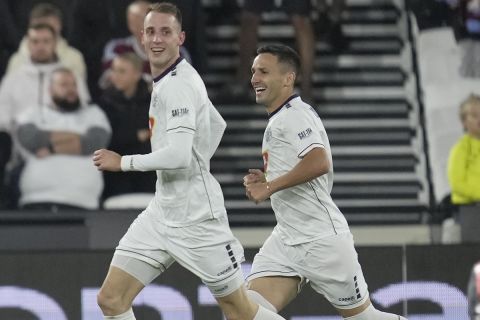 TSC's Petar Stanic, left, celebrates with teammate after scored his side first goal during the UEFA Europa League group A soccer match between West Ham United and FK TSC Backa Topola at London stadium in London, Thursday, Sept. 21, 2023. (AP Photo/Kin Cheung)