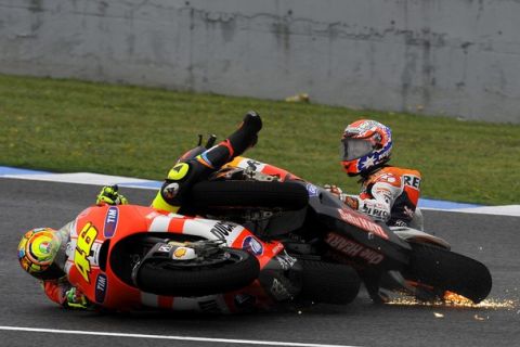 Repsol Honda Team's Australian Casey Stoner (R) and Ducati Team's Italian Valentino Rossi (L) crash during the MotoGP race of the Spanish Prix at Jerez's racetrack in Jerez de la Frontera on April 3, 2011.  AFP PHOTO/ JORGE GUERRERO (Photo credit should read Jorge Guerrero/AFP/Getty Images)