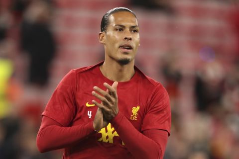 Liverpool's Virgil van Dijk warms up prior to the Champions League soccer match between Liverpool and Bologna at the Anfield stadium in Liverpool, England, Wednesday, Oct. 2, 2024. (AP Photo/Ian Hodgson)