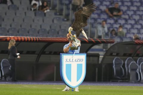 Lazio falconer holds Olympia, Lazio's mascot eagle prior to the start of a group E Europa League soccer match between Lazio and Marseille, at Rome's Olympic Stadium, Thursday, Oct. 21, 2021. (AP Photo/Gregorio Borgia)