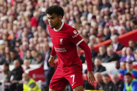 Liverpool's Luis Diaz, right, in action against Everton's Ashley Young during the English Premier League soccer match between Liverpool and Everton, at Anfield in Liverpool, England, Saturday, Oct. 21, 2023. (AP Photo/Jon Super)