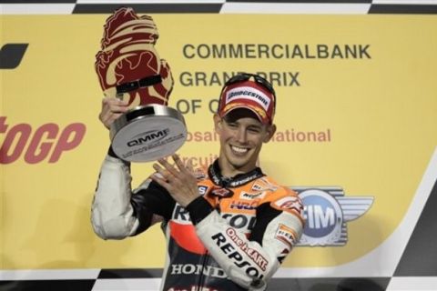 MotoGP Honda rider and first place winner Casey Stoner of Australia celebrates on the podium at the end of the Grand Prix of Qatar at the Losail International Circuit in Doha, Qatar, Sunday, March 20, 2011. (AP Photo/Hassan Ammar)