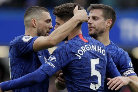 Chelsea's Mateo Kovacic, left, Cesar Azpilicueta, right, and Jorginho celebrate their team winning the English Premier League soccer match against Tottenham Hotspur in London, England, Saturday, Feb. 22, 2020. (AP Photo/Kirsty Wigglesworth)