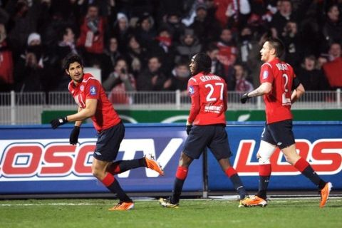 Lille's Brazilian forward Tulio De Melo (L) celebrates with teammates after scoring a goal during their French L1 football match Lille vs Lens on January 29, 2011 at Lille Metropole Stadium in Villeneuve d'Ascq. AFP PHOTO DENIS CHARLET (Photo credit should read DENIS CHARLET/AFP/Getty Images)