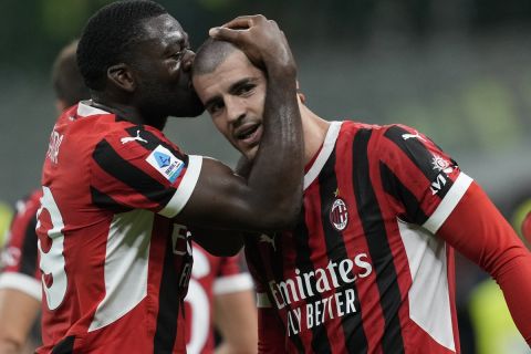 AC Milan players celebrate after a goal during the Serie A soccer match between AC Milan and Lecce at the San Siro stadium in Milan, Italy, Friday, Sept. 27, 2024. (AP Photo/Antonio Calanni)