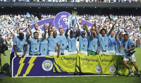 Manchester City players lift the English Premier League trophy after the soccer match between Manchester City and Huddersfield Town at Etihad stadium in Manchester, England, Sunday, May 6, 2018. (AP Photo/Rui Vieira)