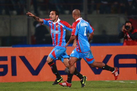 Catania's midfielder Francesco Lodi (L) jubilates with midfielder Sergio Almiron of Argentina (R) after he scored a goal against Inter Milan during their Italian Serie A  football match at Massimino Stadium on October 15, 2011.
AFP PHOTO / Marcello PATERNOSTRO . (Photo credit should read MARCELLO PATERNOSTRO/AFP/Getty Images)