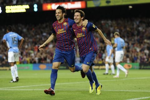 BARCELONA, SPAIN - SEPTEMBER 17:  Lionel Messi of FC Barcelona (R) celebrates with his teammate Cesc Fabregas after scoring his first team's goalduring the La Liga soccer match between FC Barcelona and CA Osasuna at Camp Nou Stadium on September 17, 2011 in Barcelona, Spain.  (Photo by David Ramos/Getty Images)