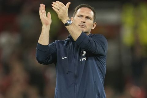 Chelsea's head coach Frank Lampard applauds supporters at the end of the English Premier League soccer match between Manchester United and Chelsea at the Old Trafford stadium in Manchester, England, Thursday, May 25, 2023. (AP Photo/Dave Thompson)