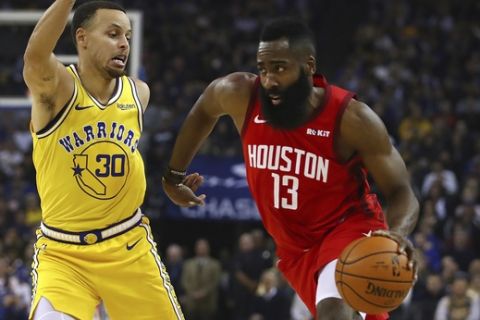 Houston Rockets' James Harden, right, is defended by Golden State Warriors' Stephen Curry (30) during the first half of an NBA basketball game Thursday, Jan. 3, 2019, in Oakland, Calif. (AP Photo/Ben Margot)