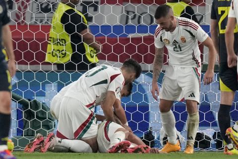 Hungary's Barnabas Varga, lies on the pitch after a collision during a Group A match between Scotland and Hungary at the Euro 2024 soccer tournament in Stuttgart, Germany, Sunday, June 23, 2024. (AP Photo/Matthias Schrader)