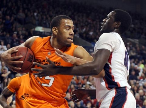 Dec 31, 2010; Spokane, WA, USA; Gonzaga Bulldogs forward Mangisto Arop (right) tries to get the ball away from Oklahoma State Cowboys forward Darrell Williams (left) during the first half at the McCarthey Athletic Center. Mandatory Credit: James Snook-US PRESSWIRE