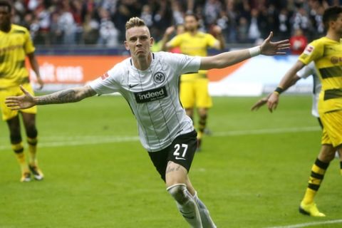 Frankfurt's Marius Wolf celebrates his side's second goal during a German first division Bundesliga match between Eintracht Frankfurt and Borussia Dortmund in Frankfurt, Germany, Saturday, Oct. 21, 2017. (AP Photo/Michael Probst)