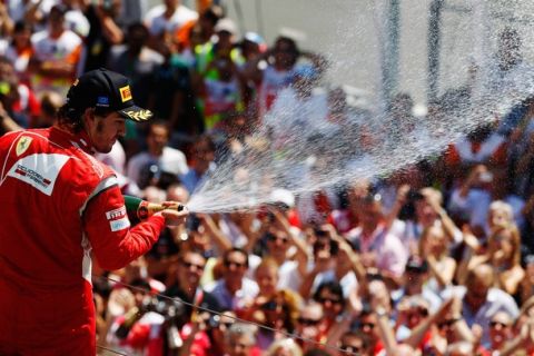 VALENCIA, SPAIN - JUNE 26:  Fernando Alonso of Spain and Ferrari celebrates on the podium after finishing second during the European Formula One Grand Prix at the Valencia Street Circuit on July 26, 2011, in Valencia, Spain.  (Photo by Mark Thompson/Getty Images)