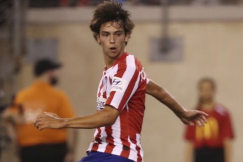 Atletico Madrid forward Joao Felix, left, watches Real Madrid goalkeeper Thibaut Courtois save a shot on goal during the first half of an International Champions Cup soccer match, Friday, July 26, 2019, in East Rutherford, N.J. Atletico Madrid won 7-3. (AP Photo/Steve Luciano)