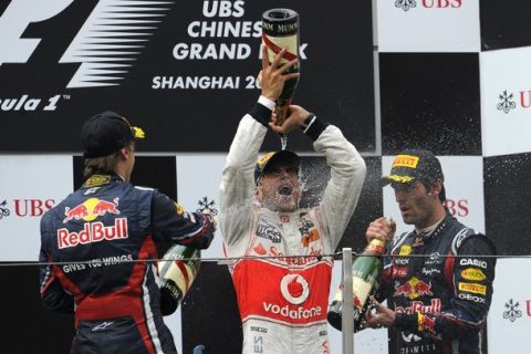 McLaren-Mercedes driver Lewis Hamilton of Britain (C), Red Bull-Renault driver Sebastian Vettel of Germany (L) and his teammate Mark Webber of Australia (R) spray champagne each other on the podium after Hamilton won the Formula One Chinese Grand Prix at in Shanghai on April 17, 2011. AFP PHOTO / LIU JIN (Photo credit should read LIU JIN/AFP/Getty Images)