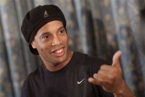 Brazil's soccer striker Ronaldinho gestures as he arrives for a press conference in Rio de Janeiro, Brazil, Thursday Jan. 6, 2011.  Ronaldinho says he has reached an agreement with AC Milan to officially end his contract with the Italian club, but did not announce his new club.  (AP Photo/Felipe Dana)