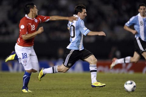 Argentine Lionel Messi (R) is marked by Chilean Gonzalo Jara during a Brazil 2014 World Cup South American qualifier match held at the Monumental stadium in Buenos Aires on October 7, 2011. Argentina won 4-1. AFP PHOTO / ALEJANDRO PAGNI (Photo credit should read ALEJANDRO PAGNI/AFP/Getty Images)