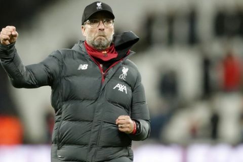 Liverpool's manager Jurgen Klopp celebrates at the end of the English Premier League soccer match between West Ham Utd and Liverpool at the London Stadium in London, Wednesday, Jan. 29, 2020. (AP Photo/Frank Augstein)