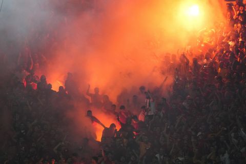 Galatasaray's supporters celebrate the opening goal during the Turkish Super Lig soccer match between Fenerbahce and Galatasaray at the Sukru Saracoglu in Istanbul, Turkey, Saturday, Sept. 21, 2024. (AP Photo/Francisco Seco)