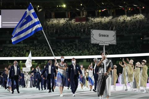 Anna Korakaki and Eleftherios Petrounias, of Greece, carry their country's flag during the opening ceremony in the Olympic Stadium at the 2020 Summer Olympics, Friday, July 23, 2021, in Tokyo, Japan. (AP Photo/Petr David Josek)