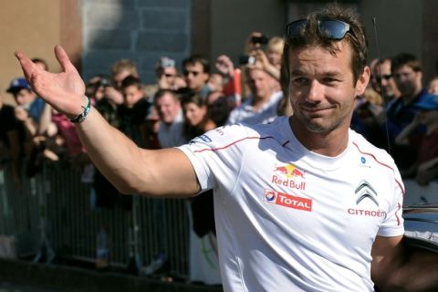 France's rally driver Sebastien Loeb waves to his fans in the streets of his home city of Haguenau, eastern France, on October 02, 2011, during the third stage of France?s Rallye Alsace. Loeb resigned during the first stage after an engine problem.   AFP PHOTO / PATRICK HERTZOG (Photo credit should read PATRICK HERTZOG/AFP/Getty Images)