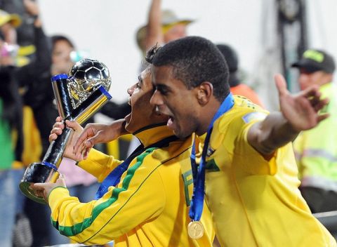 Brazilian players celebrate with the trophy after beating Portugal in the FIFA 2011 Under-20 World Cup final match in Bogota on August 20, 2011. Brazil won 3-2 in overtime. AFP PHOTO / AIZAR RALDES (Photo credit should read AIZAR RALDES/AFP/Getty Images)