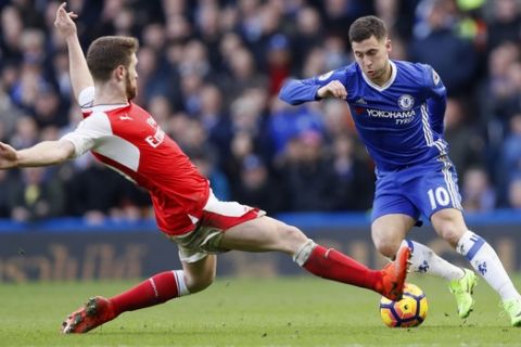 Chelsea's Eden Hazard, right avoids a tackle by Arsenal's Shkodran Mustafi during the English Premier League soccer match between Chelsea and Arsenal at Stamford Bridge stadium in London, Saturday, Feb. 4, 2017. (AP Photo/Kirsty Wigglesworth)