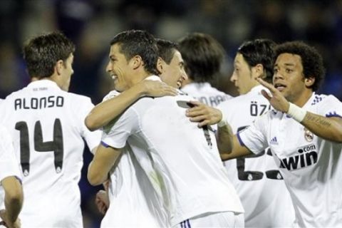 Real Madrid's Angel Di Maria from Argentina, center right, and Cristiano Ronaldo, center left, celebrate after scoring against Hercules their Spain League soccer match at the Rico Perez stadium in Alicante, on Saturday, Oct. 30, 2010. (AP Photo/Alberto Saiz)