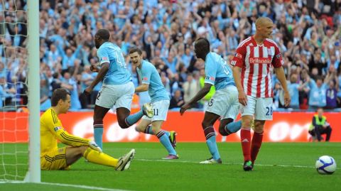 Manchester City's Ivorian footballer Yaya Toure (2nd L) wheels away in celebration after scoring against Stoke during the FA Cup final football match between Manchester City and Stoke City at Wembley Stadium in London, on May 14, 2011. AFP PHOTO / ANDREW YATES
NOT FOR MARKETING OR ADVERTISING USE/RESTRICTED TO EDITORIAL USE (Photo credit should read ANDREW YATES/AFP/Getty Images)