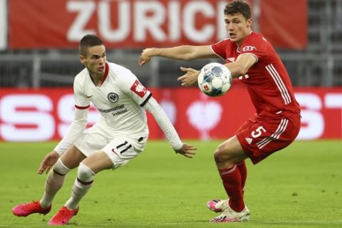 Eintracht Frankfurt's Mijat Gacinovic in action with Bayern Munich's Benjamin Pavard during the German soccer cup semi-final match between Bayern Munich and Eintracht Frankfurt in Munich, Germany, Wednesday, June 10, 2020. (Kai Pfaffenbach/Pool via AP)