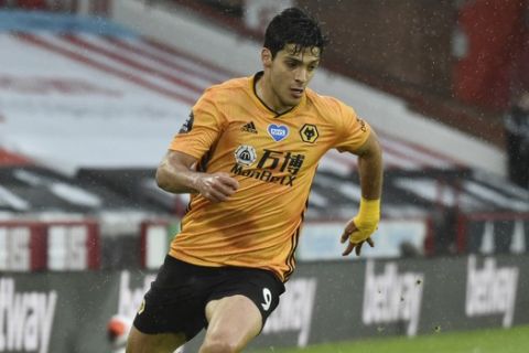 Wolverhampton Wanderers' Raul Jimenez runs with the ball during the English Premier League soccer match between Sheffield United and Wolverhampton Wanderers at Bramall Lane stadium in Sheffield, England, Wednesday, July 8, 2020. (Rui Vieira/Pool via AP)