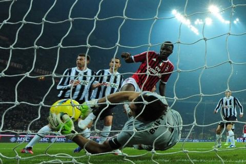 Juventus goalkeeper Gianluigi Buffon grabs the ball in front of AC Milan midfielder Sulley Ali Muntari of Ghana on February 25, 2012 during a Serie A match at the San Siro stadium in Milan. AFP PHOTO / OLIVIER MORIN (Photo credit should read OLIVIER MORIN/AFP/Getty Images)