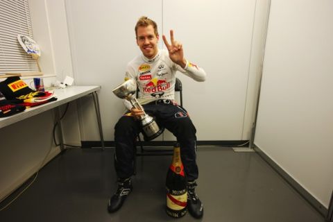 SUZUKA, JAPAN - OCTOBER 09:  Sebastian Vettel of Germany and Red Bull Racing celebrates in his changing room with the third place trophy which secured his second F1 World Drivers Championship during the Japanese Formula One Grand Prix at Suzuka Circuit on October 9, 2011 in Suzuka, Japan.  (Photo by Mark Thompson/Getty Images)