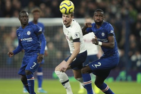 Tottenham's Harry Kane and Chelsea's Antonio Rudiger, right, eye the ball during the English Premier League soccer match between Tottenham Hotspur and Chelsea, at the Tottenham Hotspur Stadium in London, Sunday, Dec. 22, 2019. (AP Photo/Ian Walton)