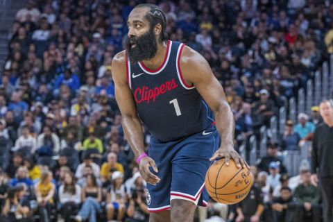 Los Angeles Clippers guard James Harden (1) dribbles past Golden State Warriors guard Buddy Hield, left, during the second half of an NBA basketball game in San Francisco, Sunday, Oct. 27, 2024. (AP Photo/Nic Coury)