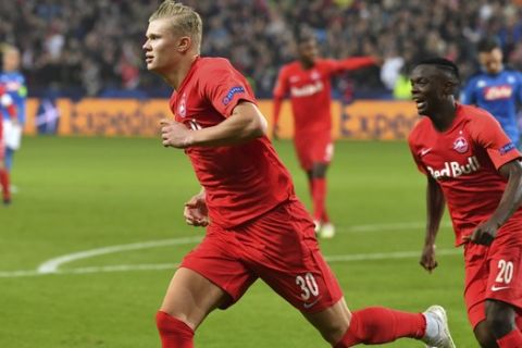 Salzburg's Erling Braut Haaland, left, celebrates after scoring the opening goal during the Champions League Group E soccer match between FC Red Bull Salzburg and Napoli in Salzburg, Austria, Wednesday, Oct. 23, 2019. (AP Photo/Kerstin Joensson)