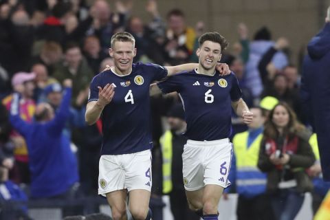 Scotland's Scott McTominay, left, celebrates with his teammate Kieran Tierney after scoring his side's second goal during the Euro 2024 group A qualifying soccer match between Scotland and Spain at the Hampden Park stadium in Glasgow, Scotland, Tuesday, March 28, 2023. (AP Photo/Scott Heppell)