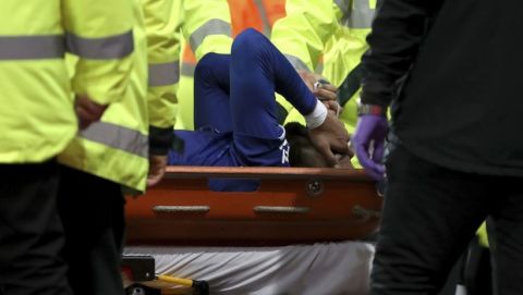 Everton's Andre Gomes is carried off the field by medical staff following a challenge by Tottenham Hotspur's Son Heung-min during the English Premier League soccer match at Goodison Park, Liverpool, England, Sunday Nov. 3, 2019. (Nick Potts/PA via AP)