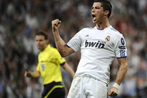 Real Madrid's Portuguese forward Cristiano Ronaldo celebrates afters scoring during the Champions League quarter-final first leg football match Real Madrid against Tottenham Hotspur at the Santiago Bernabeu stadium in Madrid, on April 5, 2011.  AFP PHOTO/ PIERRE -PHILIPPE MARCOU (Photo credit should read PIERRE-PHILIPPE MARCOU/AFP/Getty Images)