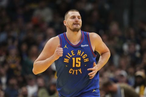 Denver Nuggets center Nikola Jokic smiles after making a basket against the Dallas Mavericks during the first half of an Emirates NBA Cup basketball game Friday, Nov. 22, 2024, in Denver. (AP Photo/Jack Dempsey)