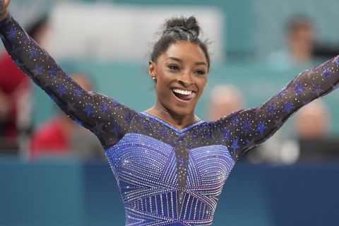 Simone Biles, of the United States, celebrates after performing on the balance beam during the women's artistic gymnastics all-around finals in Bercy Arena at the 2024 Summer Olympics, Thursday, Aug. 1, 2024, in Paris, France. (AP Photo/Francisco Seco)