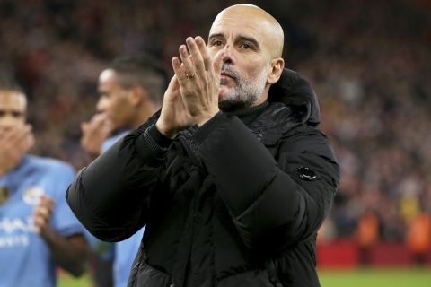 Manchester City's head coach Pep Guardiola applauds the fans at the end of the English Premier League soccer match between Liverpool and Manchester City at Anfield Stadium, Liverpool, England, Sunday Dec. 1, 2024. (AP Photo/Ian Hodgson)