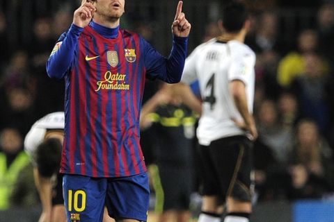 Barcelona's Argentinian forward Lionel Messi celebrates his goal during the Spanish league football match FC Barcelona vs Valencia CF on February 19, 2012 at the Camp Nou stadium in Barcelona. AFP PHOTO/ JOSEP LAGO (Photo credit should read JOSEP LAGO/AFP/Getty Images)