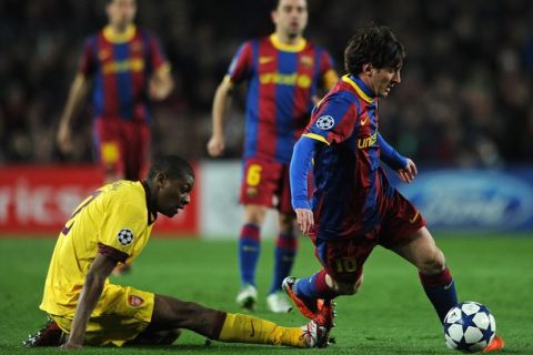 BARCELONA, SPAIN - MARCH 08:  Abou Diaby (L) of Arsenal tries to stop Lionel Messi of Barcelona during the UEFA Champions League round of 16 second leg match between Barcelona and Arsenal on March 8, 2011 in Barcelona, Spain.  (Photo by Jasper Juinen/Getty Images)