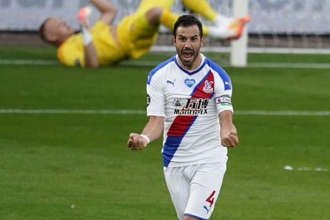 Crystal Palace's Luka Milivojevic celebrates after scoring his teams first goal during the English Premier League soccer match between Bournemouth and Crystal Palace at Vitality Stadium in Bournemouth, England, Saturday, June 20, 2020. (AP Photo/Will Oliver,Pool)