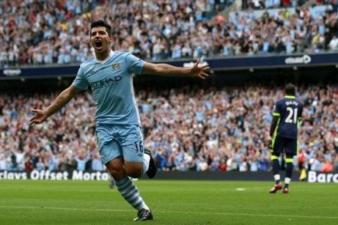 Manchester City's Sergio Aguero, left, celebrates after scoring a goal against Wigan during their English Premier League soccer match at the City of Manchester Stadium, Manchester, England, Saturday Sept. 10, 2011. (AP Photo/Tim Hales)