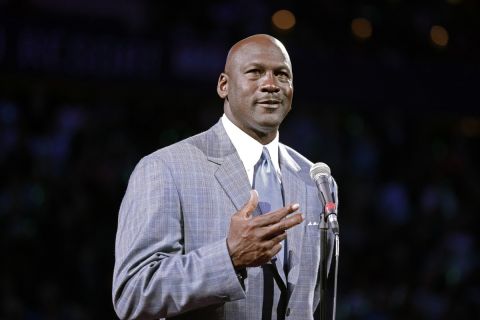 Charlotte Bobcats owner Michael Jordan speaks to fans before unveiling the new Charlotte Hornets logo during a ceremony at an NBA basketball game between the Charlotte Bobcats and the Utah Jazz in Charlotte, N.C., Saturday, Dec. 21, 2013. The Bobcats will change their name to Hornets starting next season. (AP Photo/Chuck Burton)