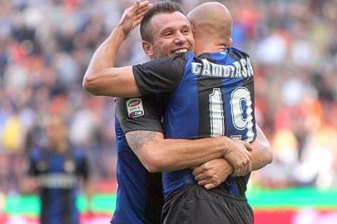 Inter forward Antonio Cassano (L) celebrates with his teammate Esteban Cambiasso after scoring the 1-0 lead against Catania during a Italian Serie A soccer match between Inter and Catania at the Giuseppe Meazza stadium in Milan, Italy, 21 October 2012. ANSA / MATTEO BAZZI